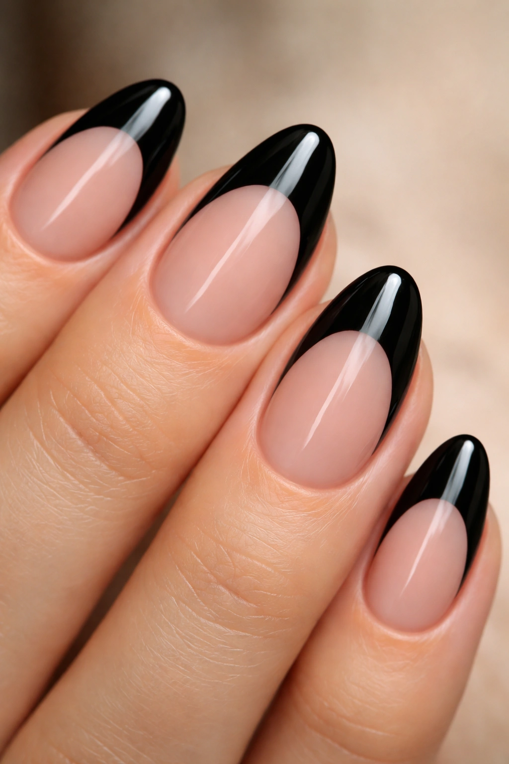 Short almond nails with black arches creating negative space design