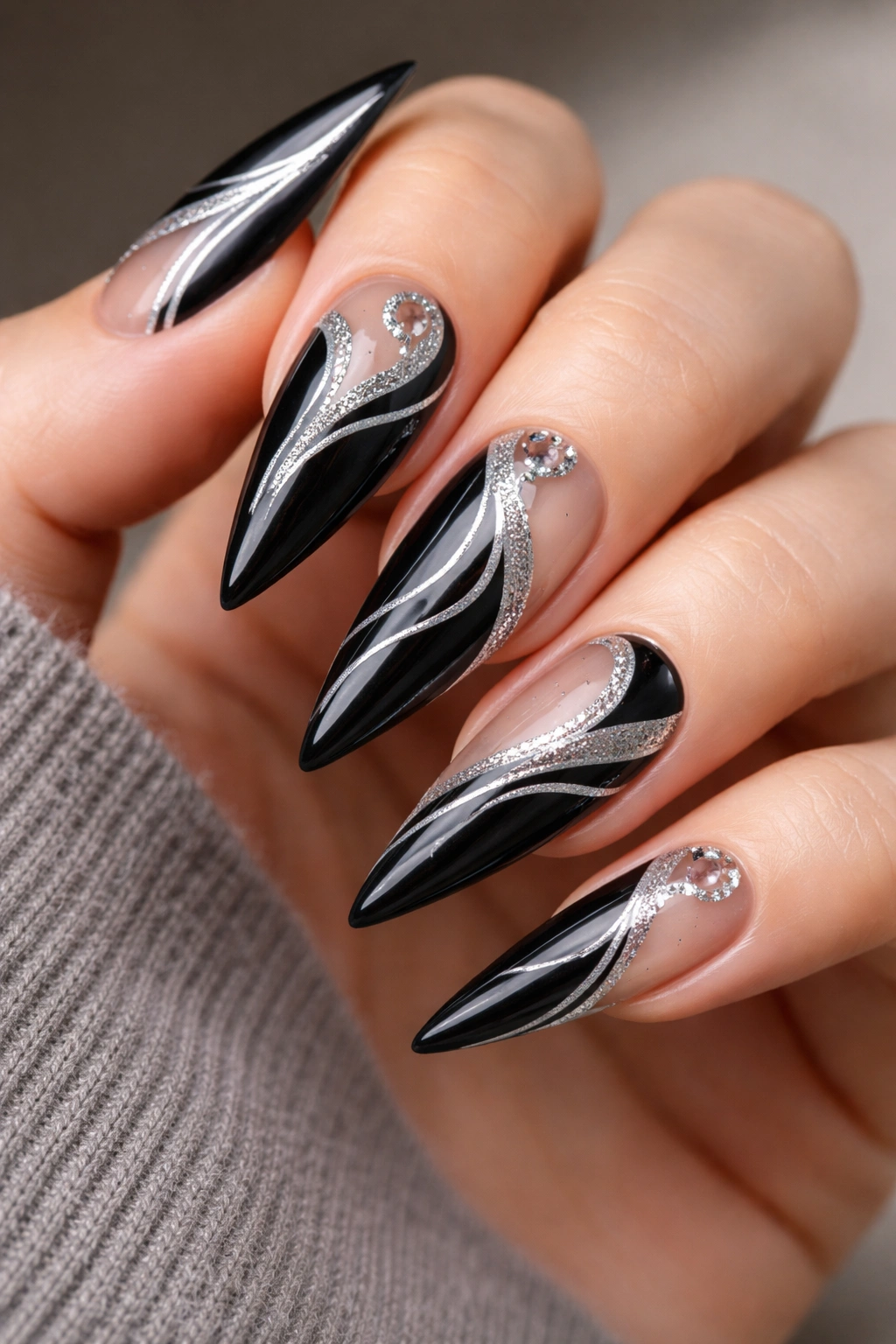 Close-up of black nails with negative space silver details