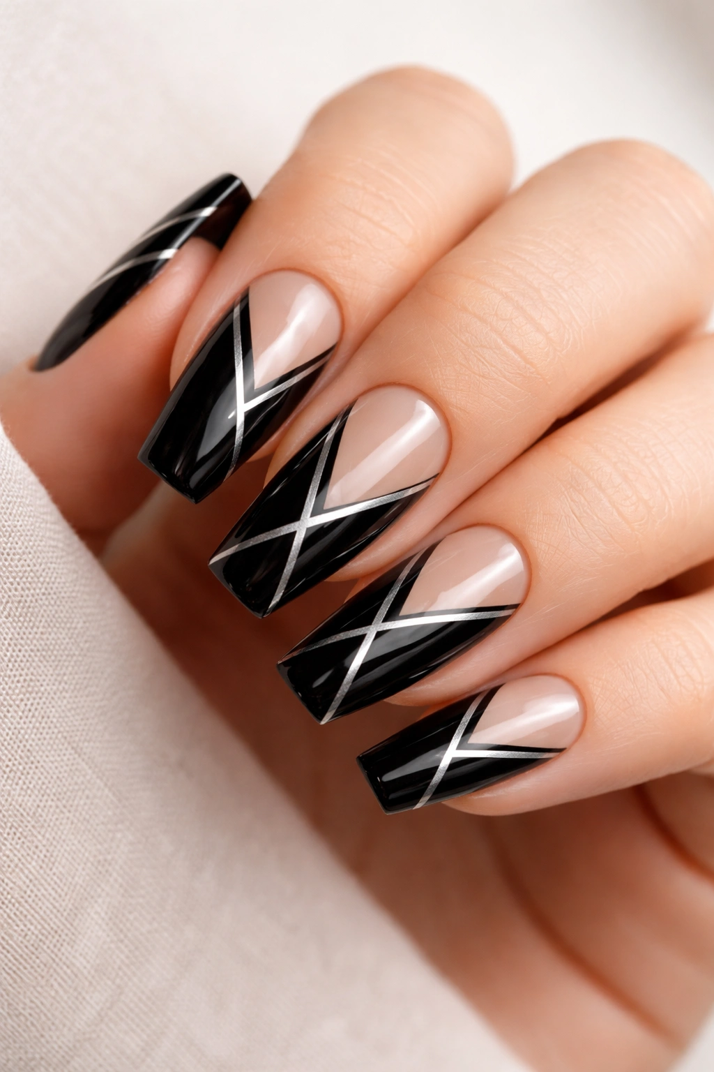 Glossy black coffin nails with silver negative-space geometric outlines.