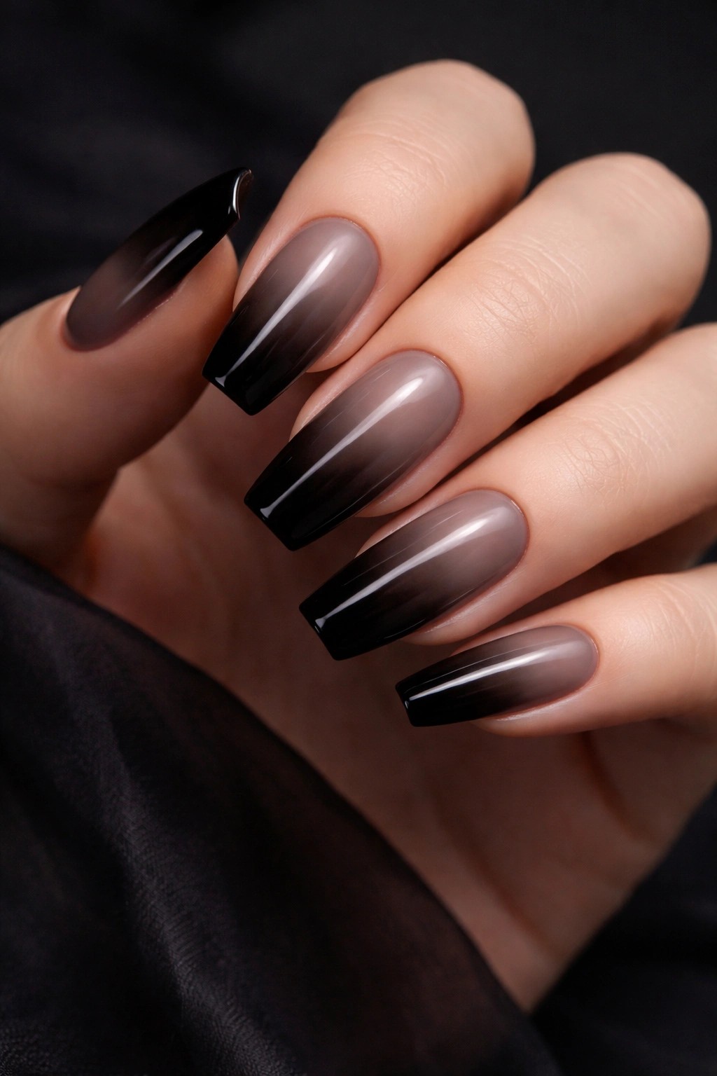 Nude-to-black gradient on coffin nails