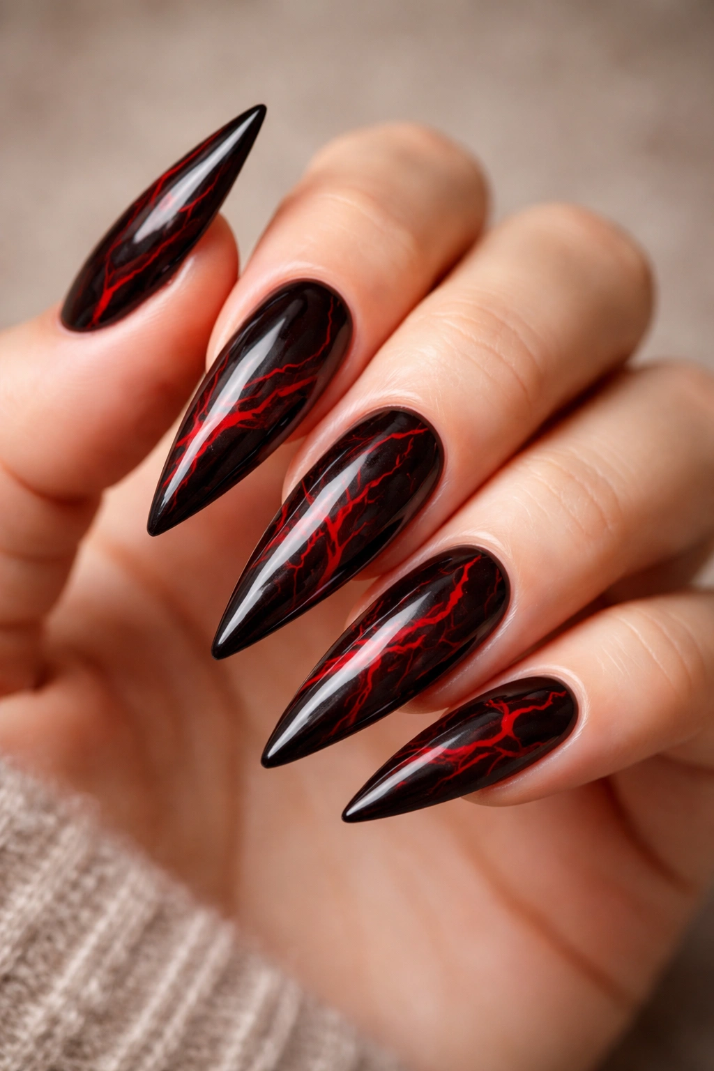 Black nails with red marble veining on stiletto nails