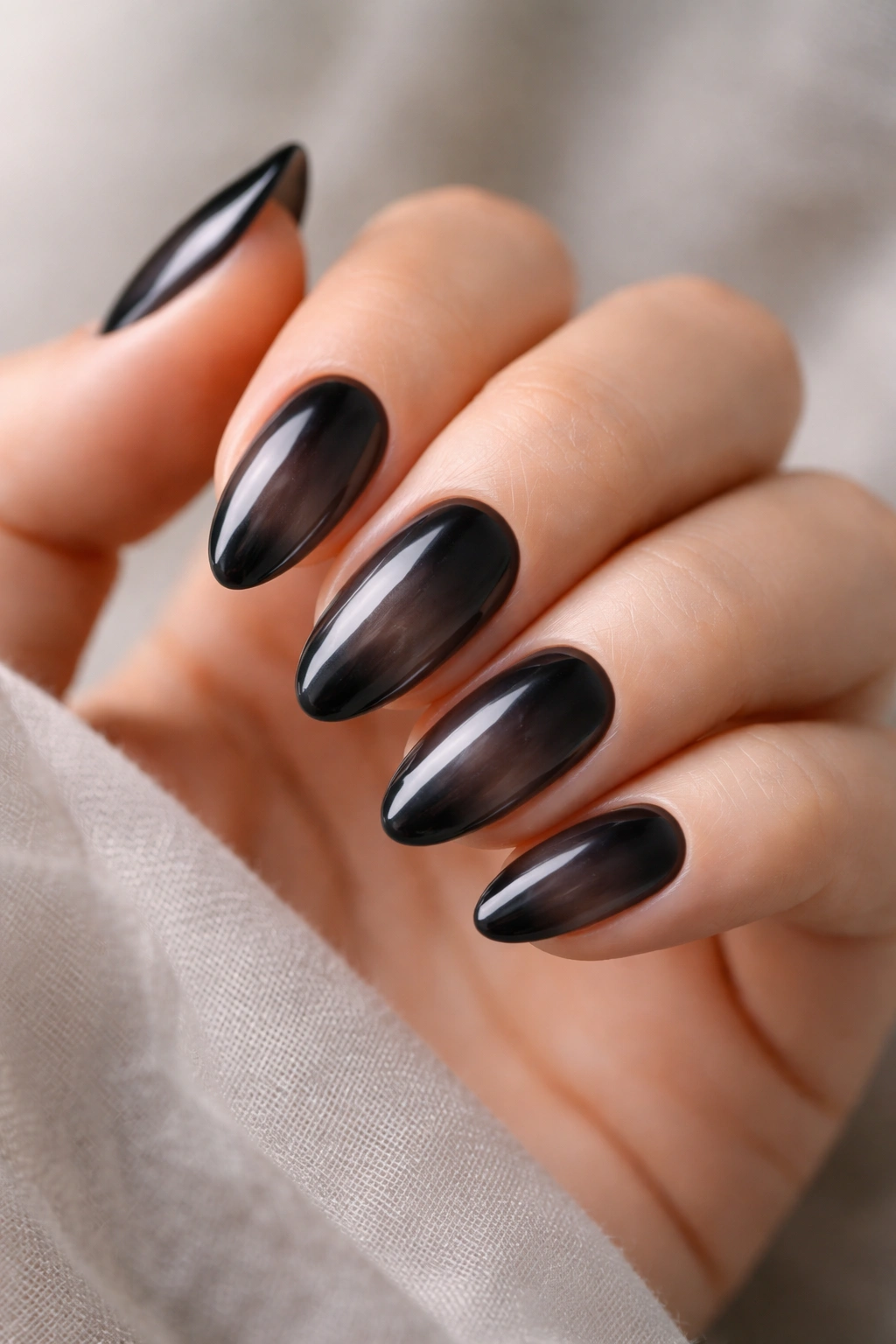 Short almond nails with sheer smoky black finish