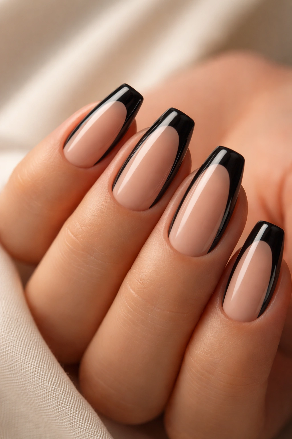 Close-up of short black ballerina nails with thin side outlines and nude center