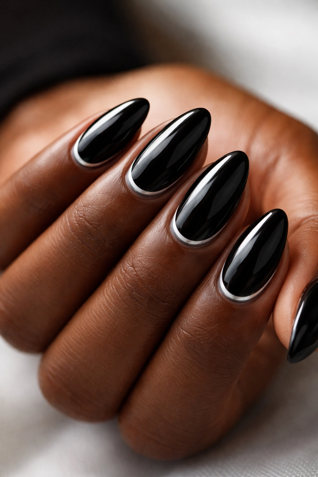 Black almond nails with a single silver chrome line