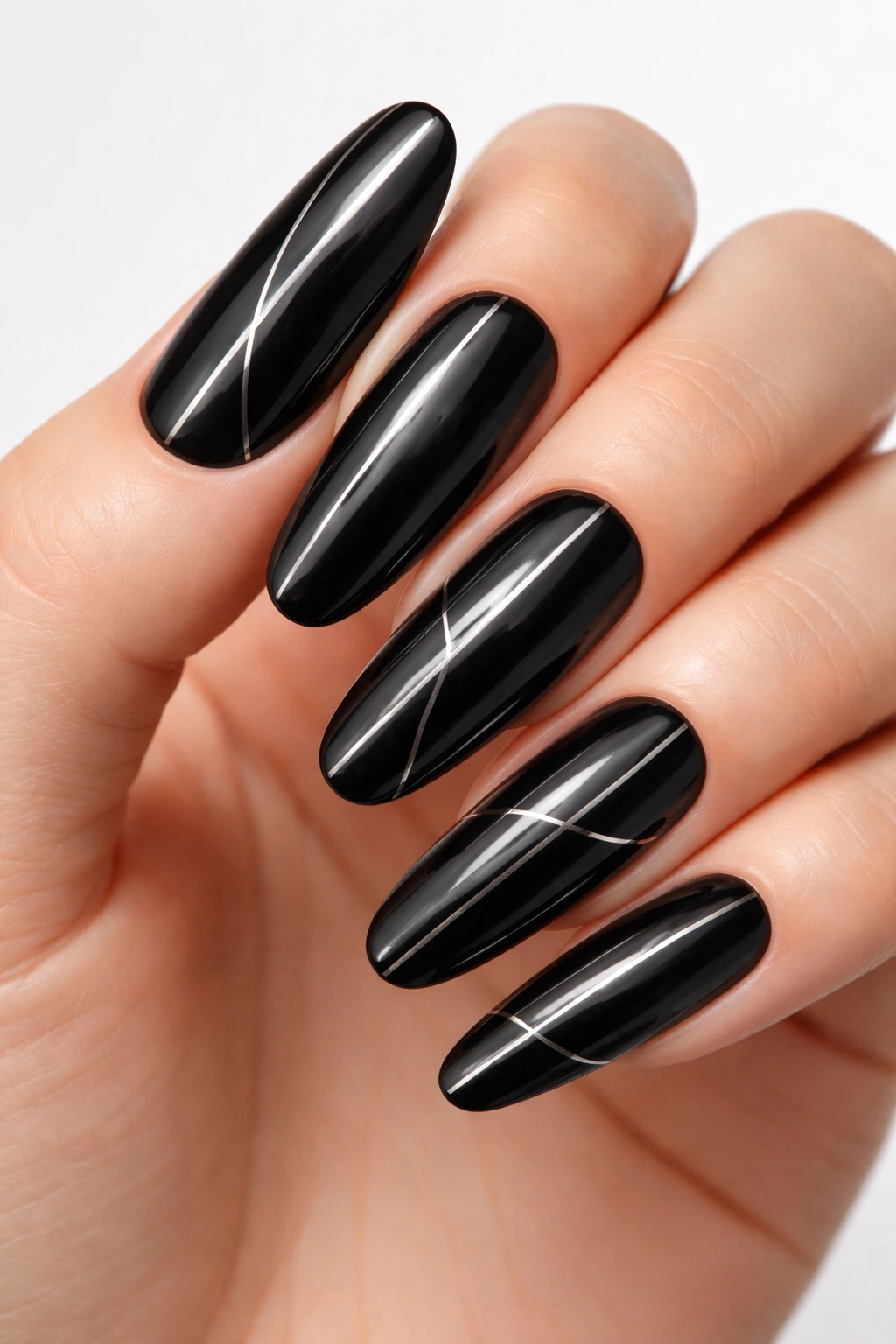 Jet-black nails with silver geometric lines on long rounds