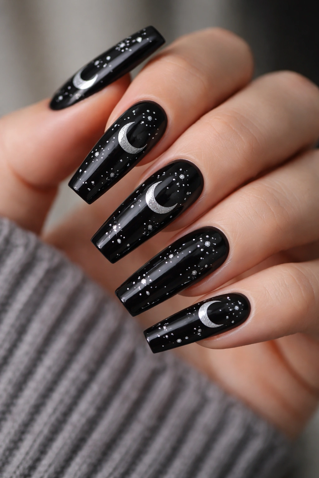Glossy black coffin nails with silver crescent moons and stars