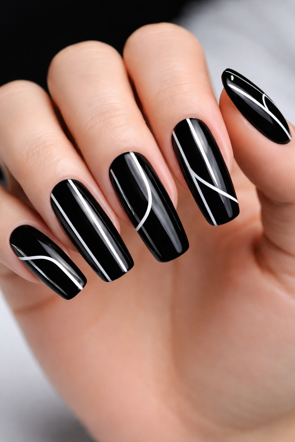 Black nails with white negative-space line design