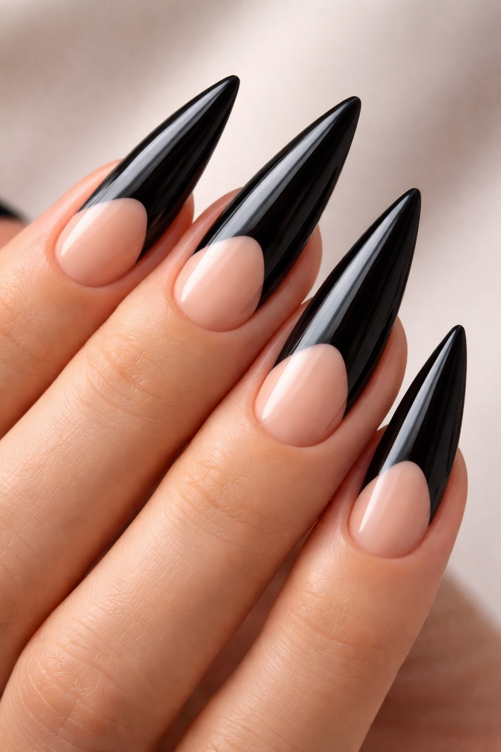 Nails with black base and nude tips showing a clean line