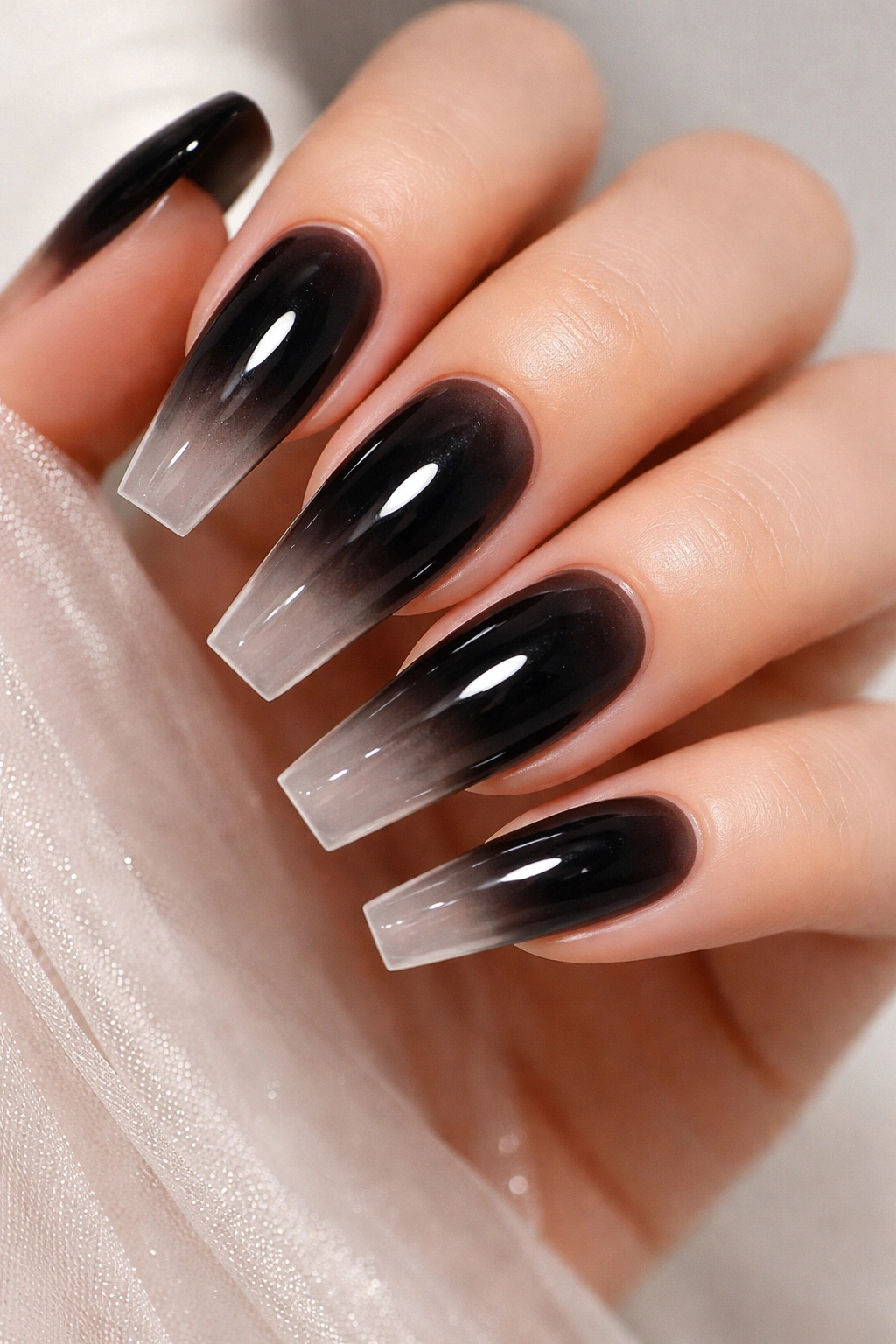Black ombre nails fading to clear with glossy finish