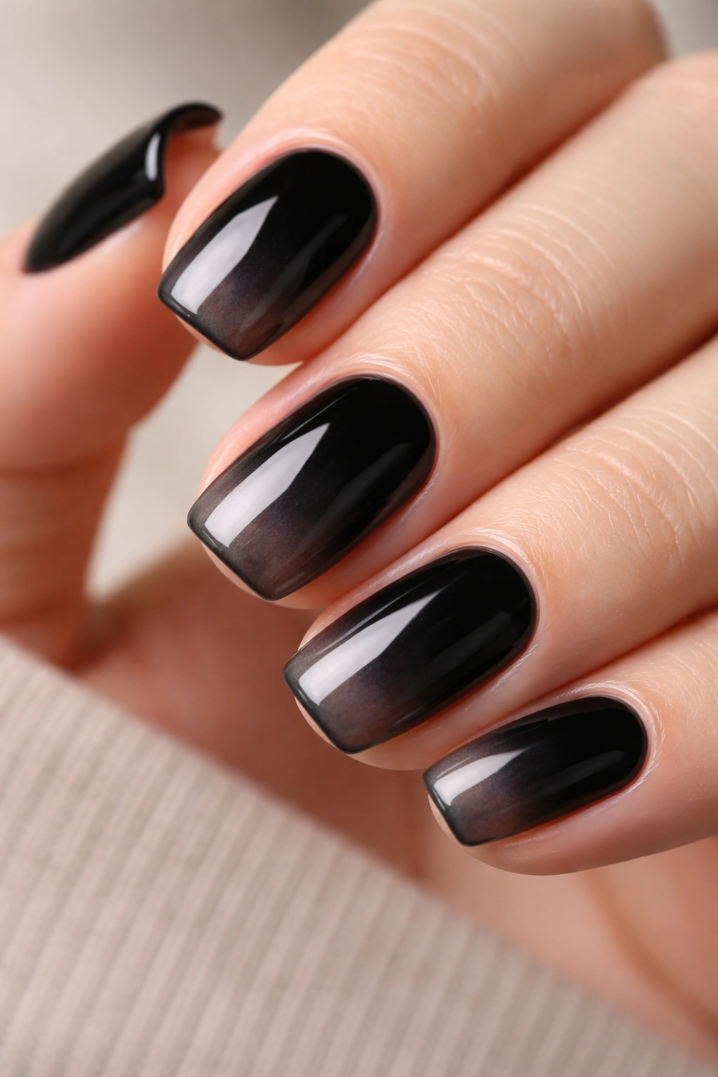 Nails featuring an opaque-to-sheer black ombré gradient
