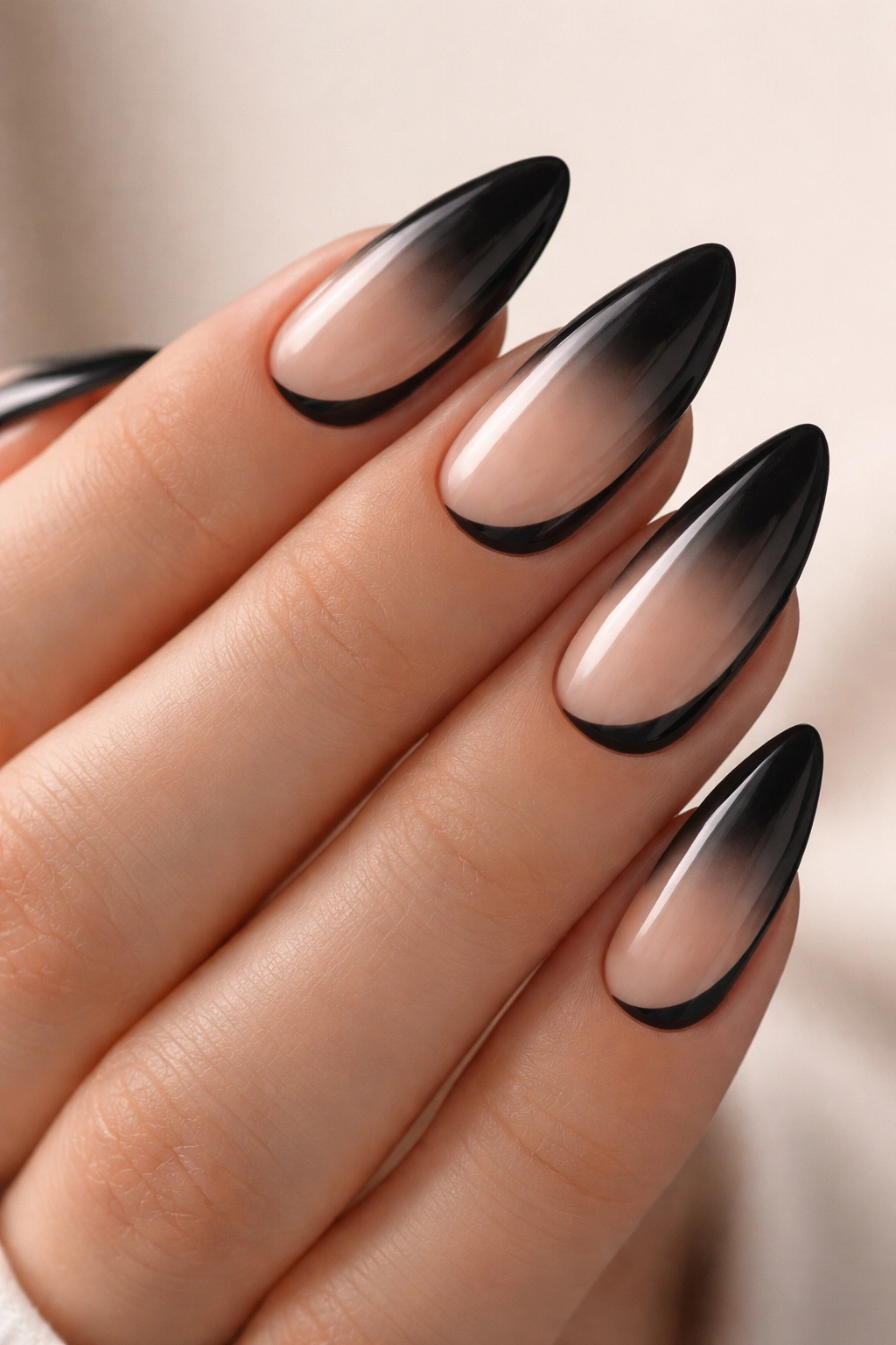 Almond nails with black ombre and nude negative space crescent