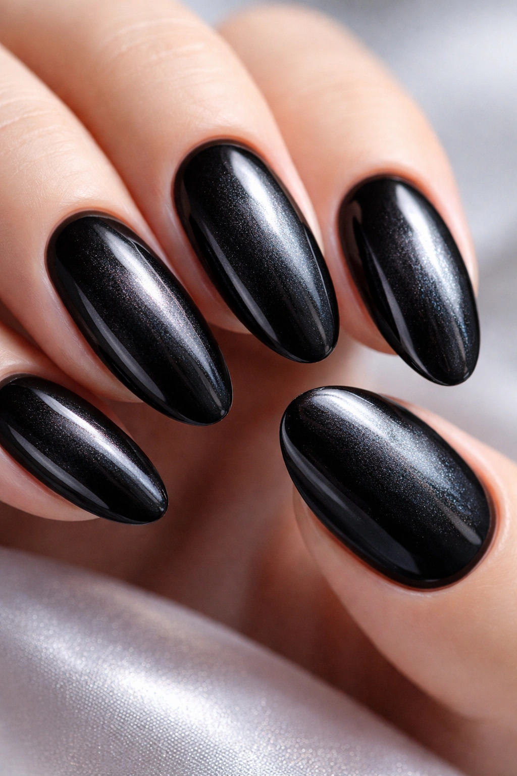 Close-up of black nails with pearl finish showing soft iridescent shimmer