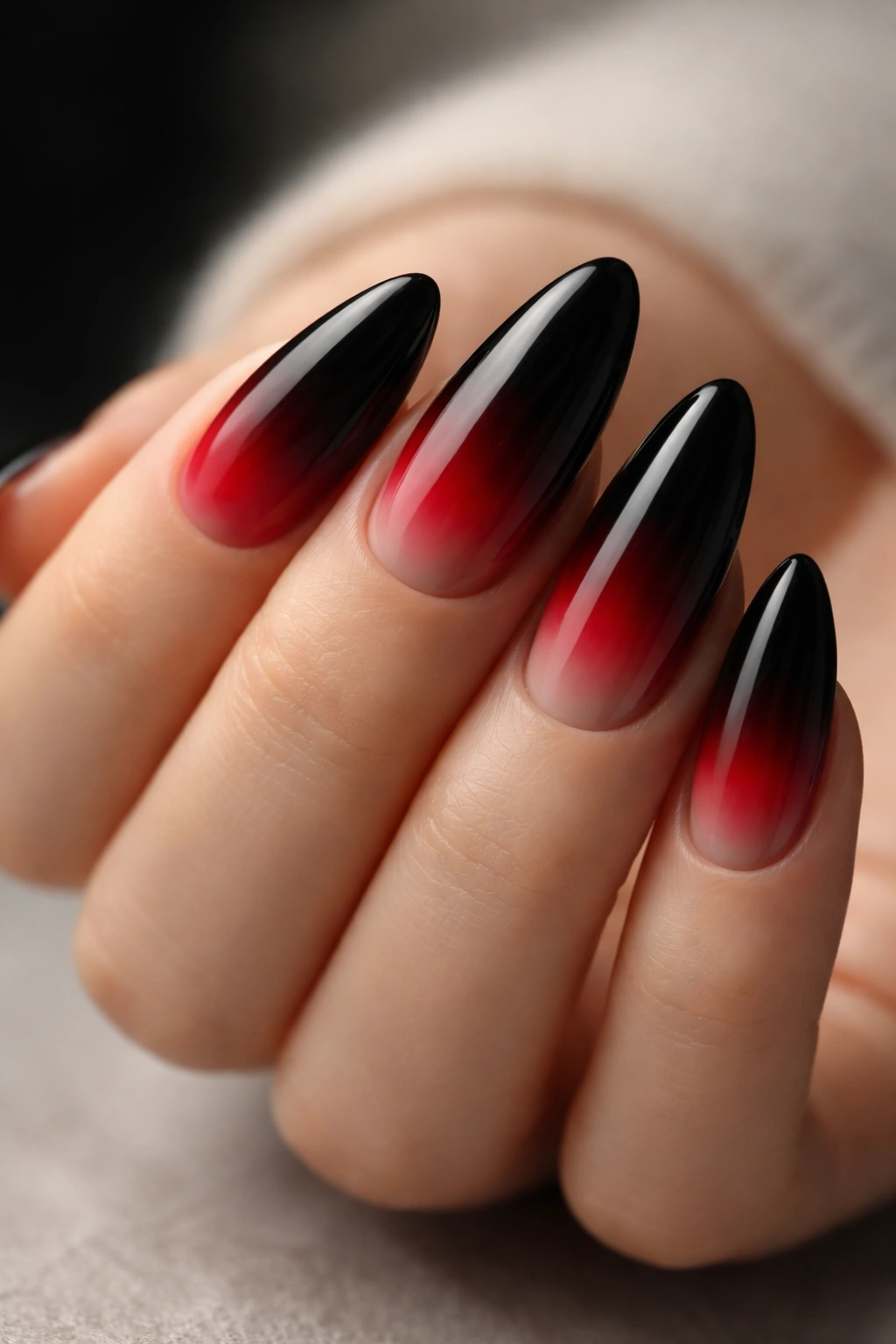 Almond nails with black-to-red ombre and smoky transition
