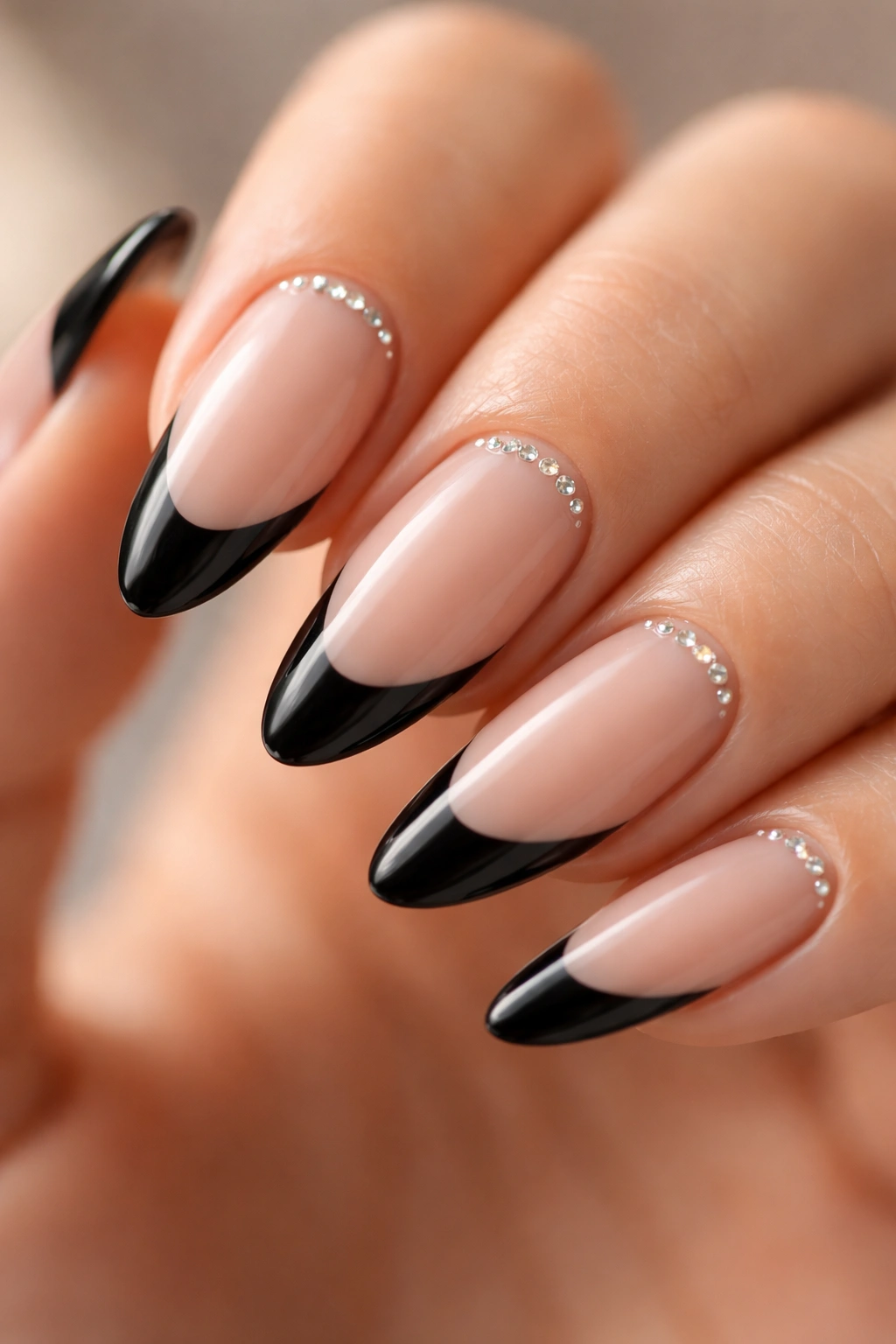 Almond nail with black tip and tiny rhinestones near cuticle