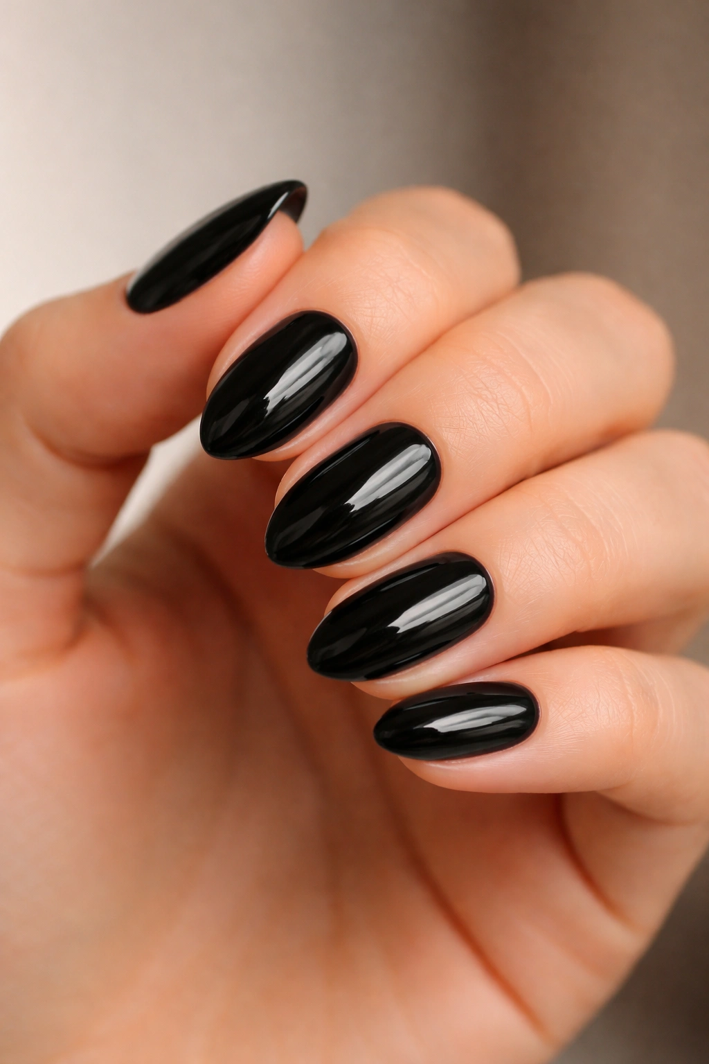 Close-up of short almond nails in glossy black