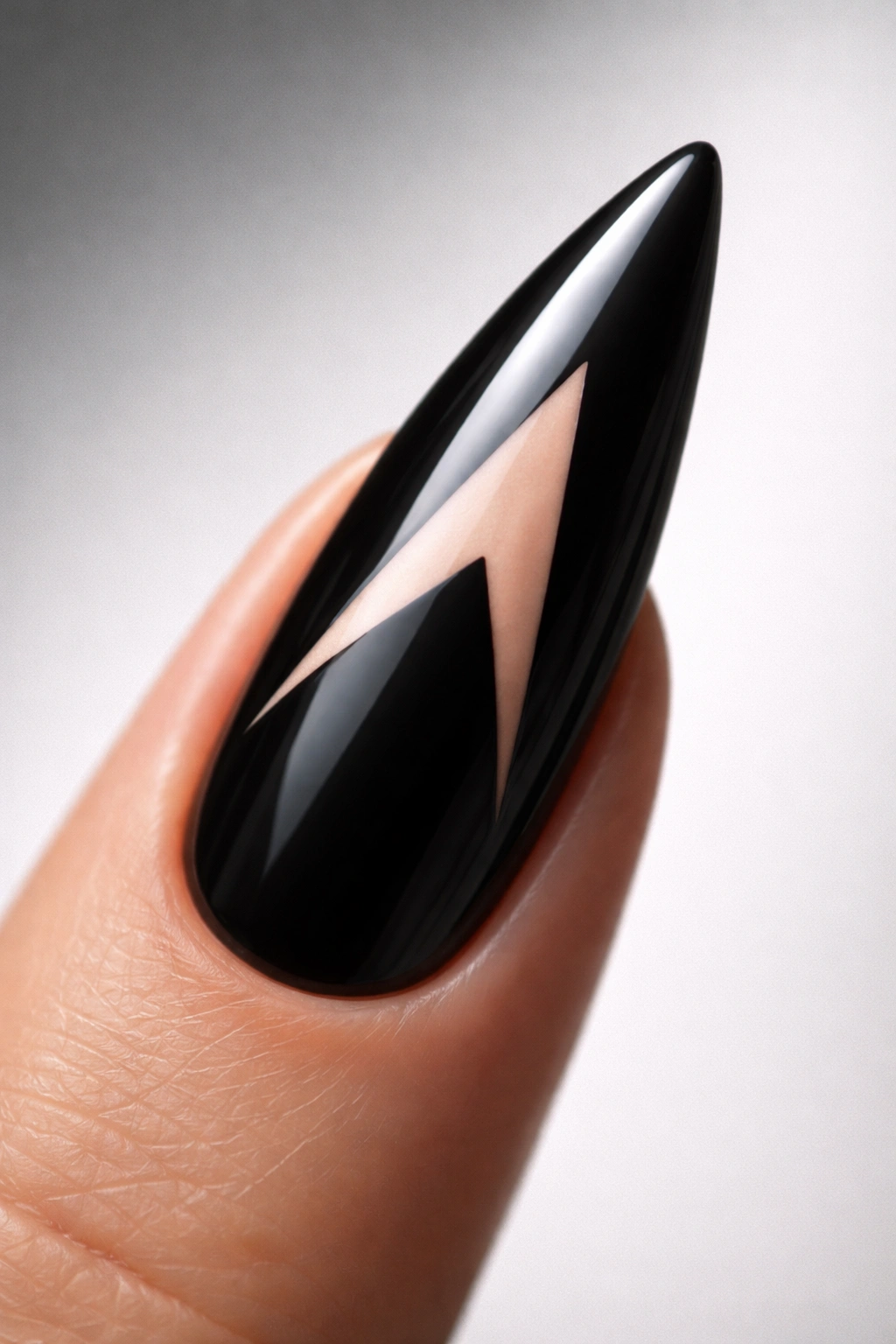 Black curved stiletto nail with negative space triangle