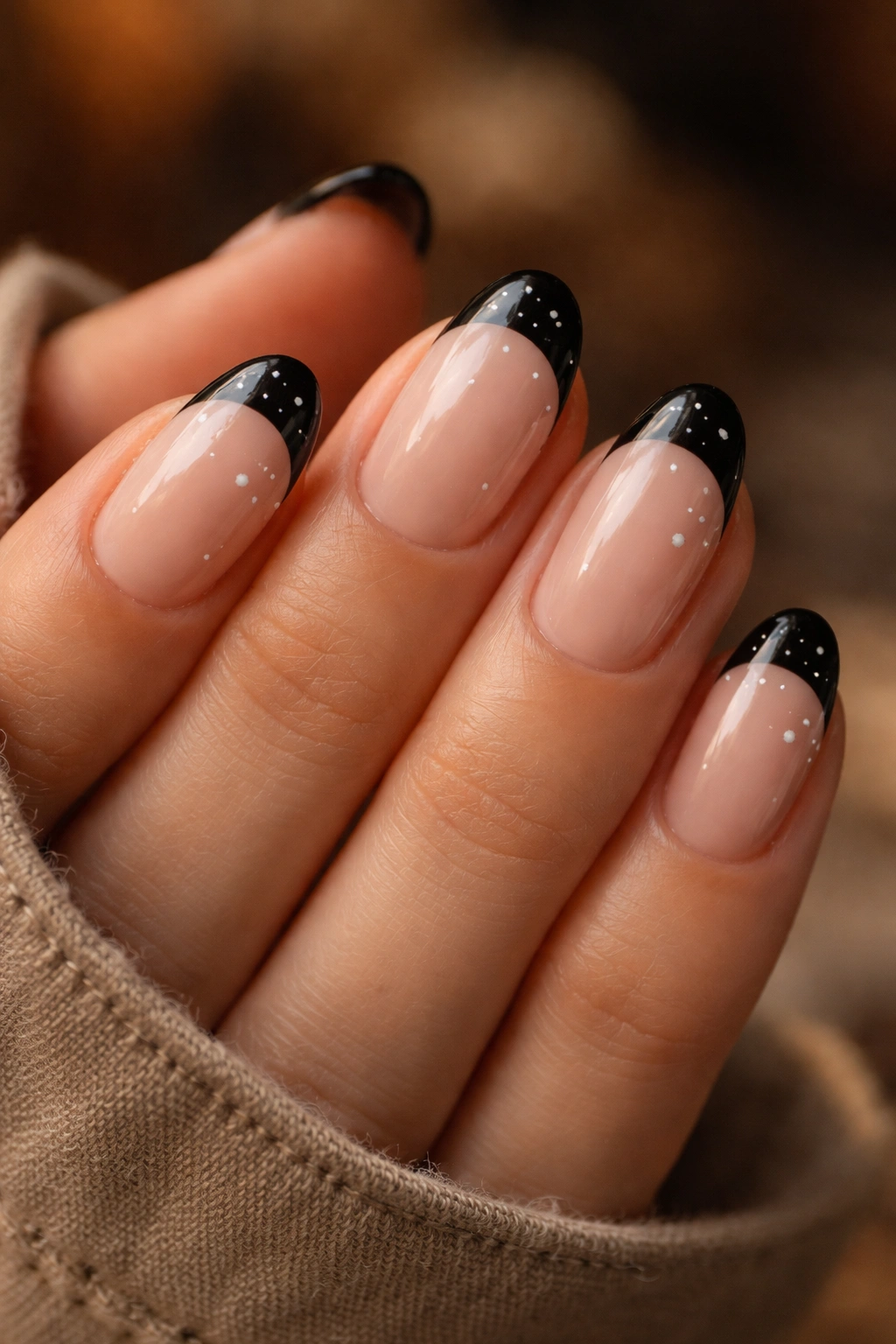Short almond nails with black tips and small star decorations