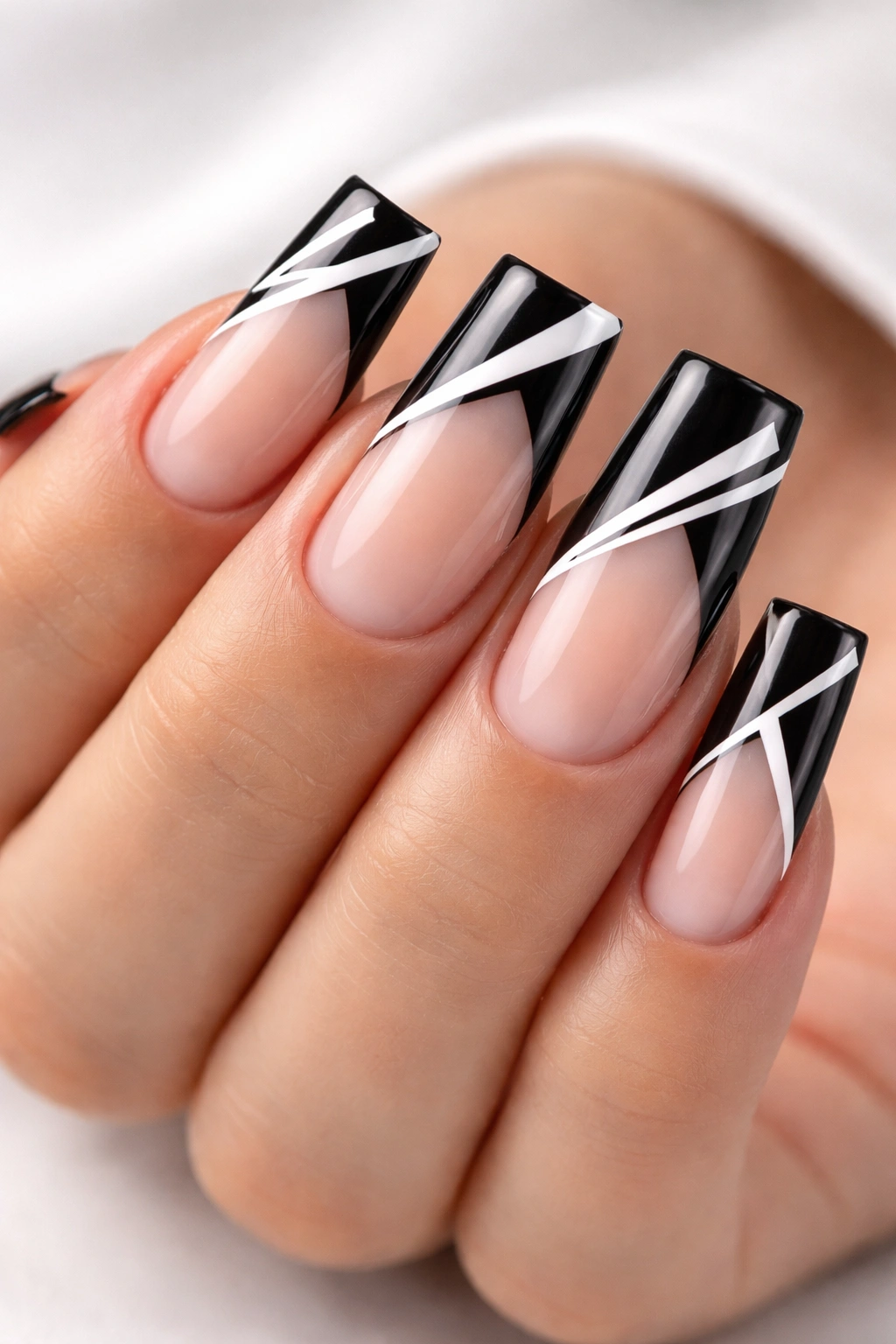 Duck nails with black tips and white geometric shapes