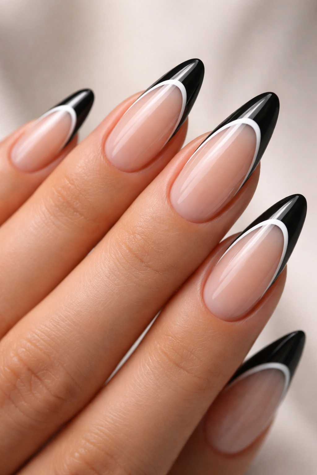 Almond nail with black tip and thin white line accent