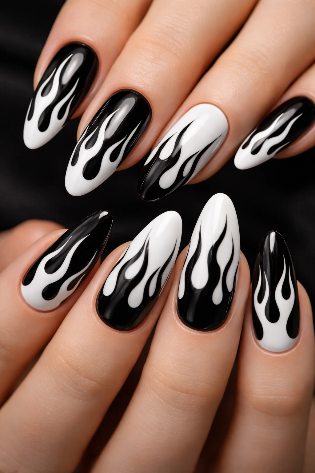Black and white flame nail art with high contrast on a dark base
