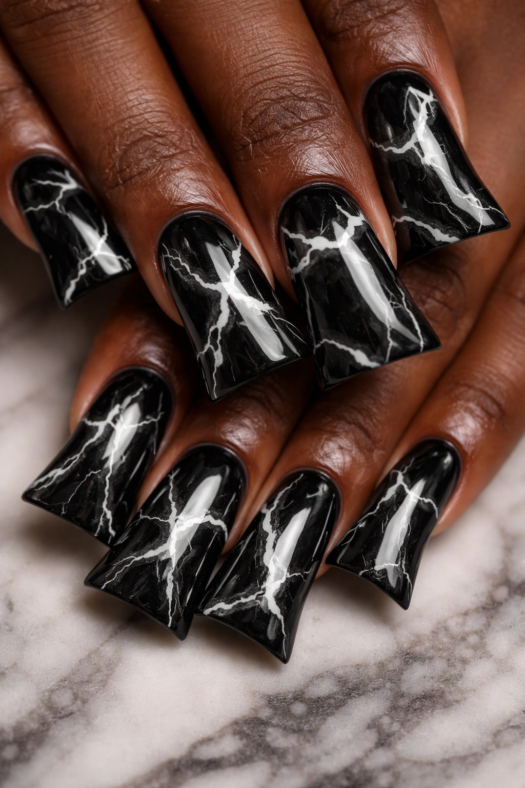 Black duck nails with white marble effect on dark skin