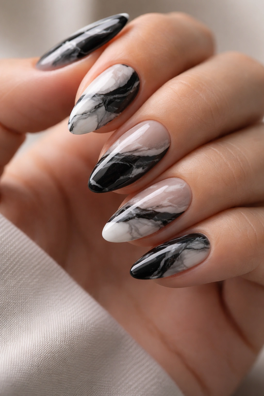 Short almond nails with black and white marble and negative space