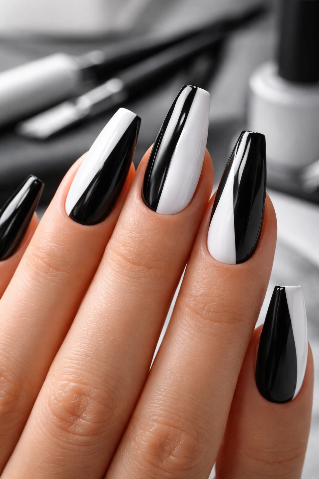 Close-up of black and white ballerina nails on a hand, showing crisp lines