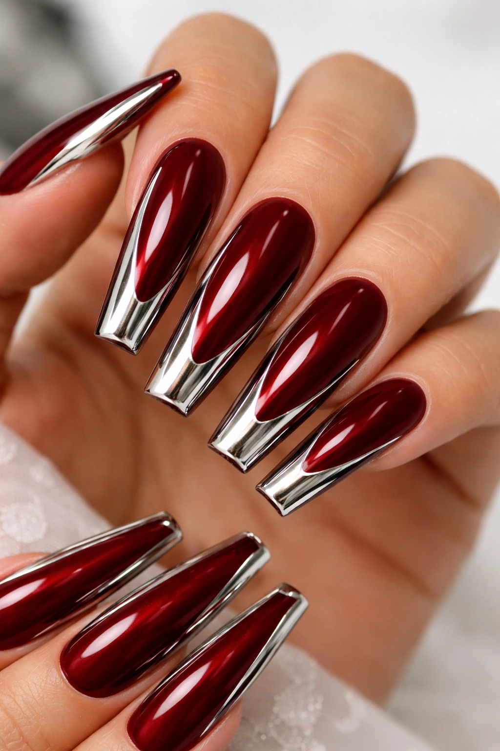Close-up of coffin nails deep red with chrome detailing