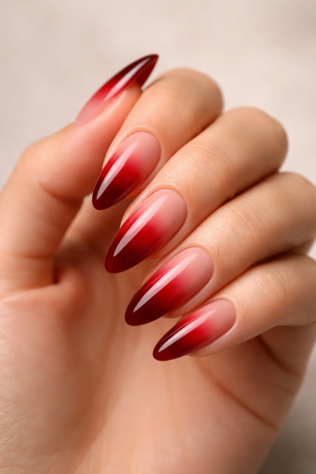 Nude-cuticle blood red ombre on long almond nails