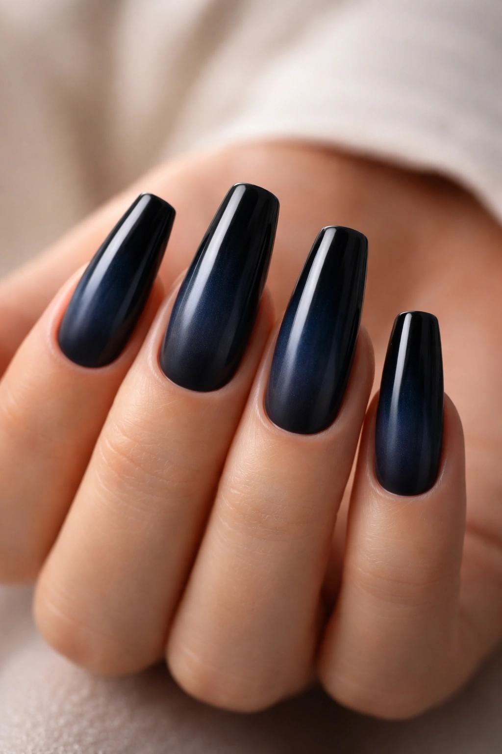 Blue-black ombre nails with a smoky fade on a ballerina shape