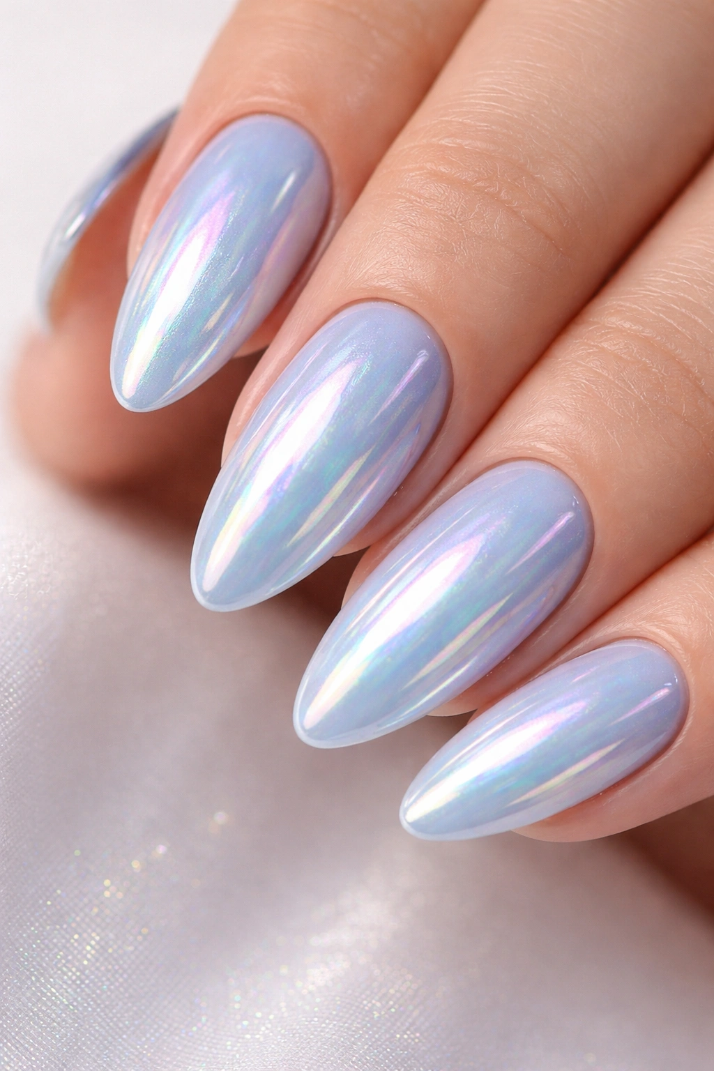 Close-up of light blue chrome nails with iridescent finish
