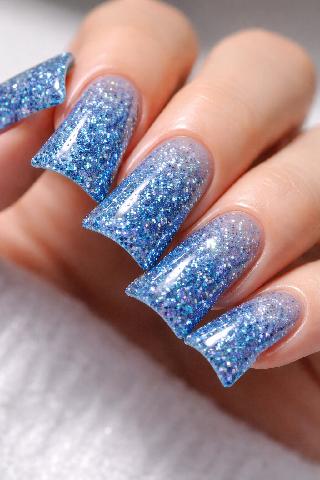 Macro shot of blue glitter duck nails
