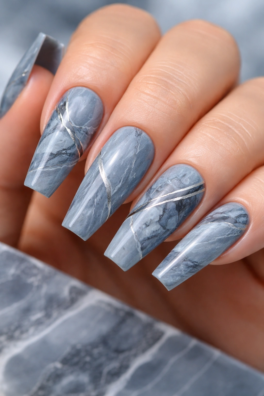 Close-up of blue-gray slate marble nails with silver veining