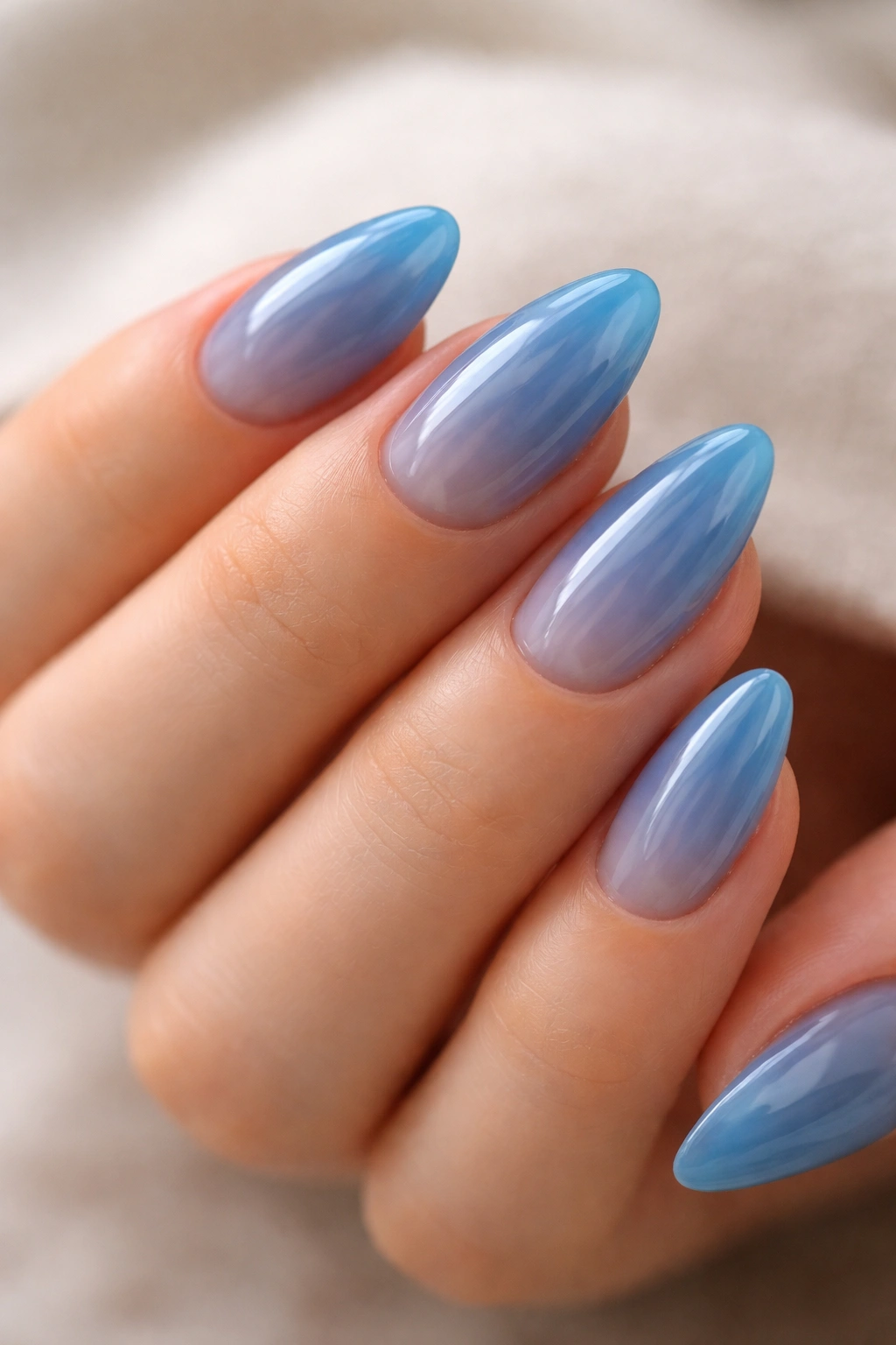 Short almond nails with translucent blue jelly finish