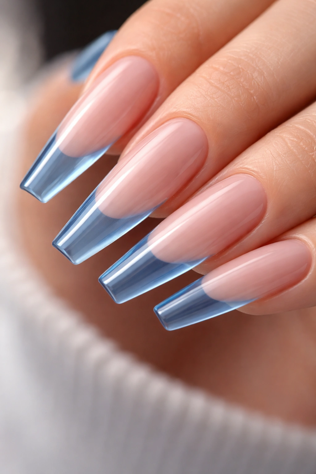 Long ballerina nail with translucent blue jelly tip on nude base