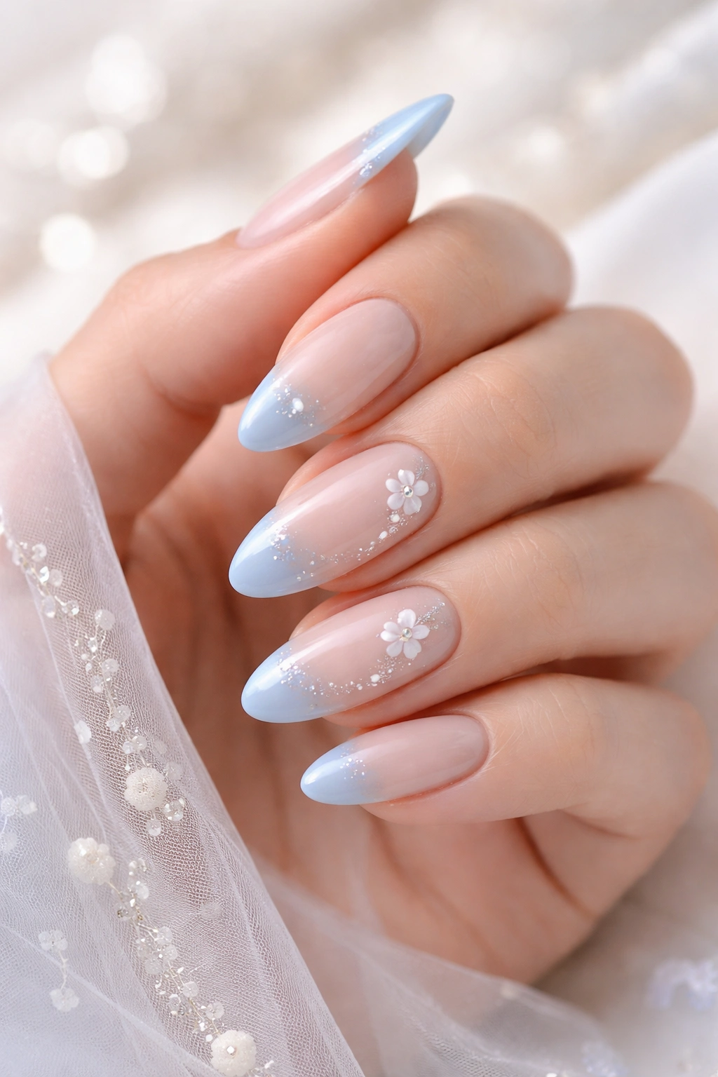 Nails featuring blue tips on a nude base for something blue design