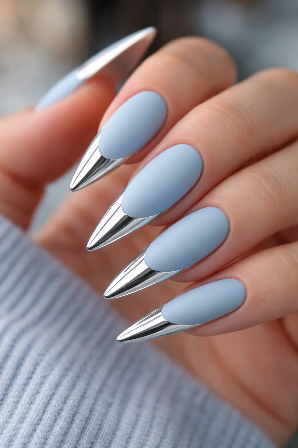Close-up of matte baby blue nails with chrome white tips