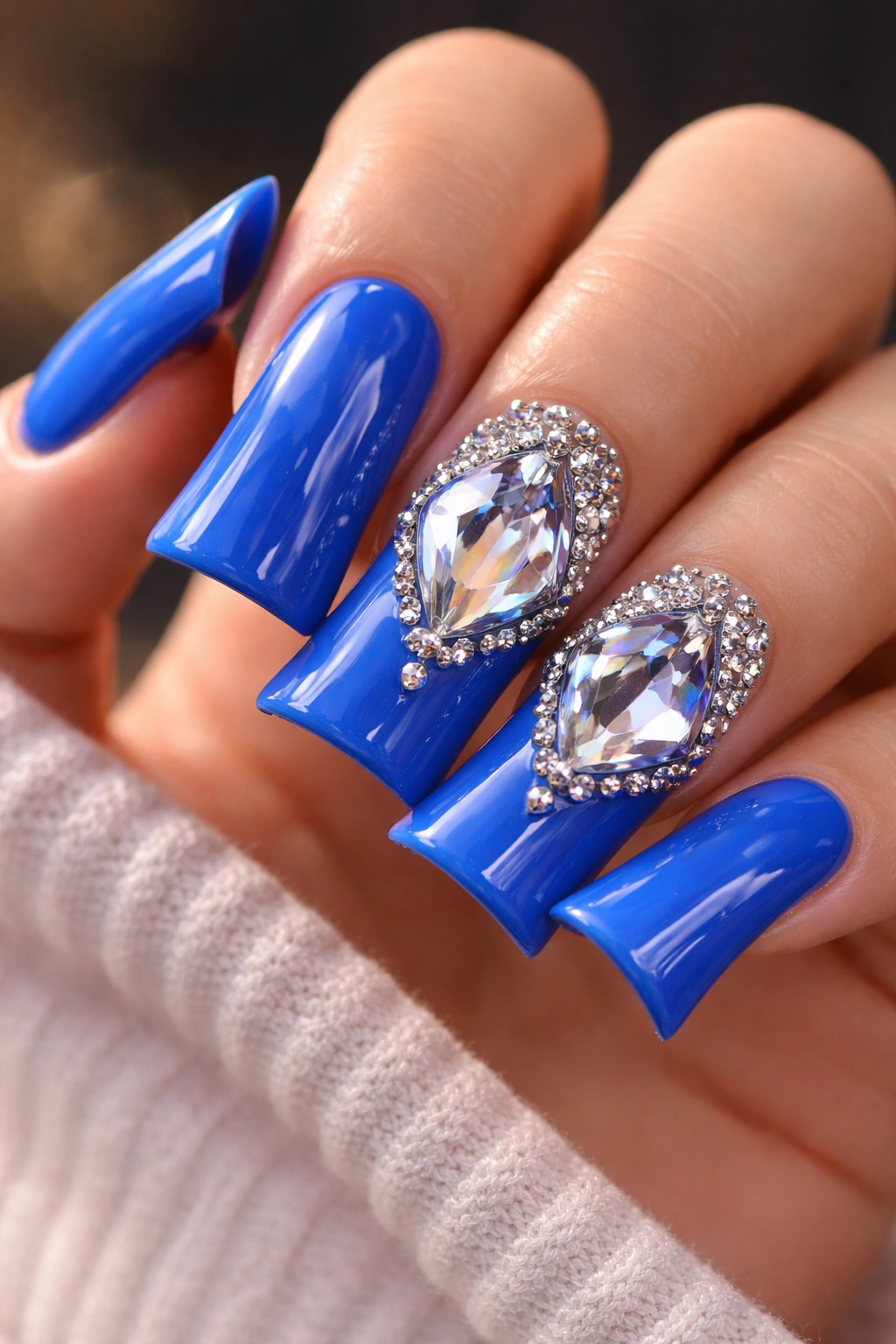 Blue nails with diamond crystal accents, macro shot