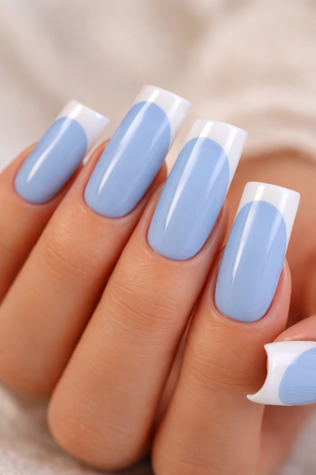Close-up of blue French tip duck nails