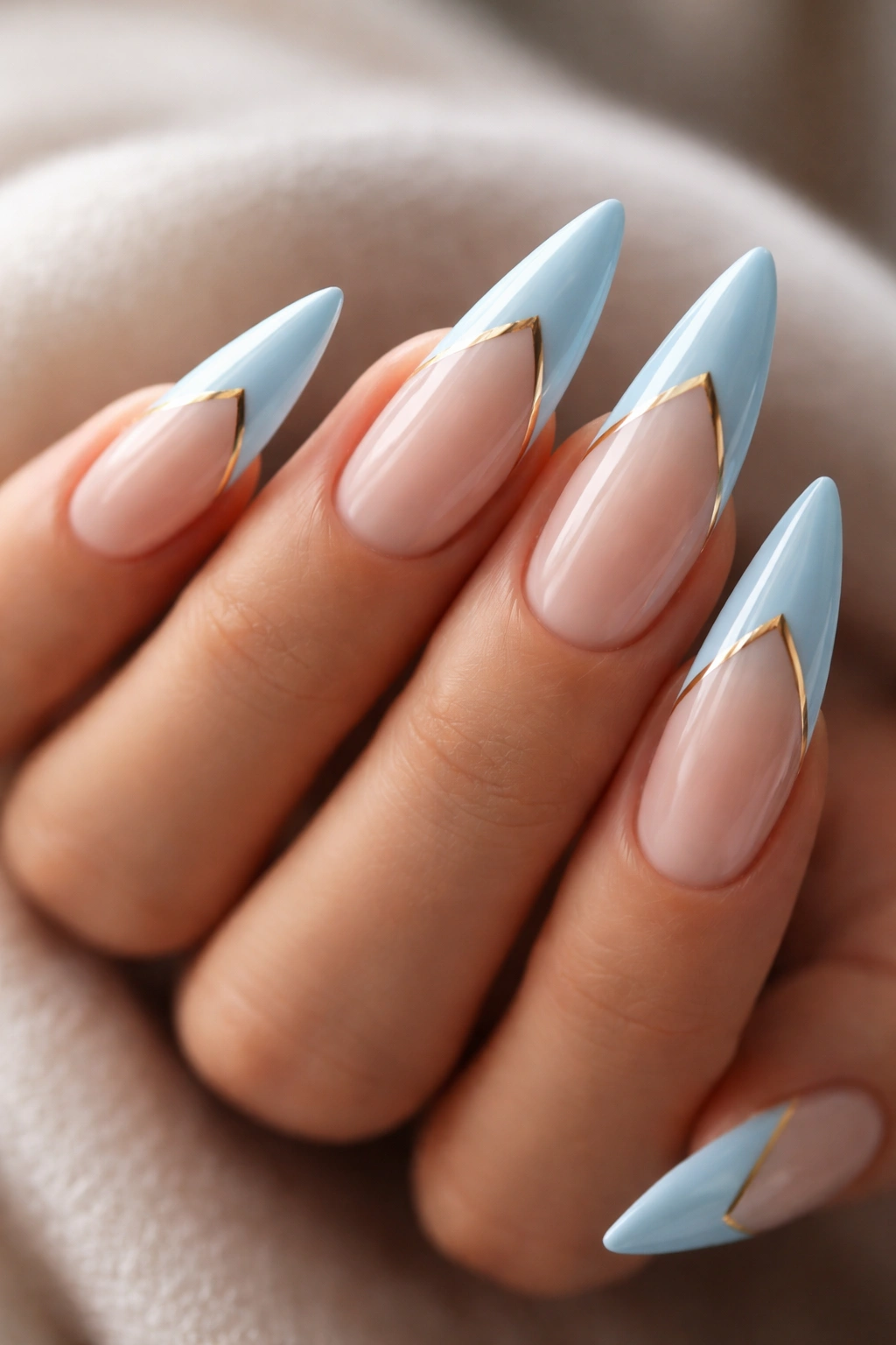 Nails with thin gold stripe along the blue-to-white transition.