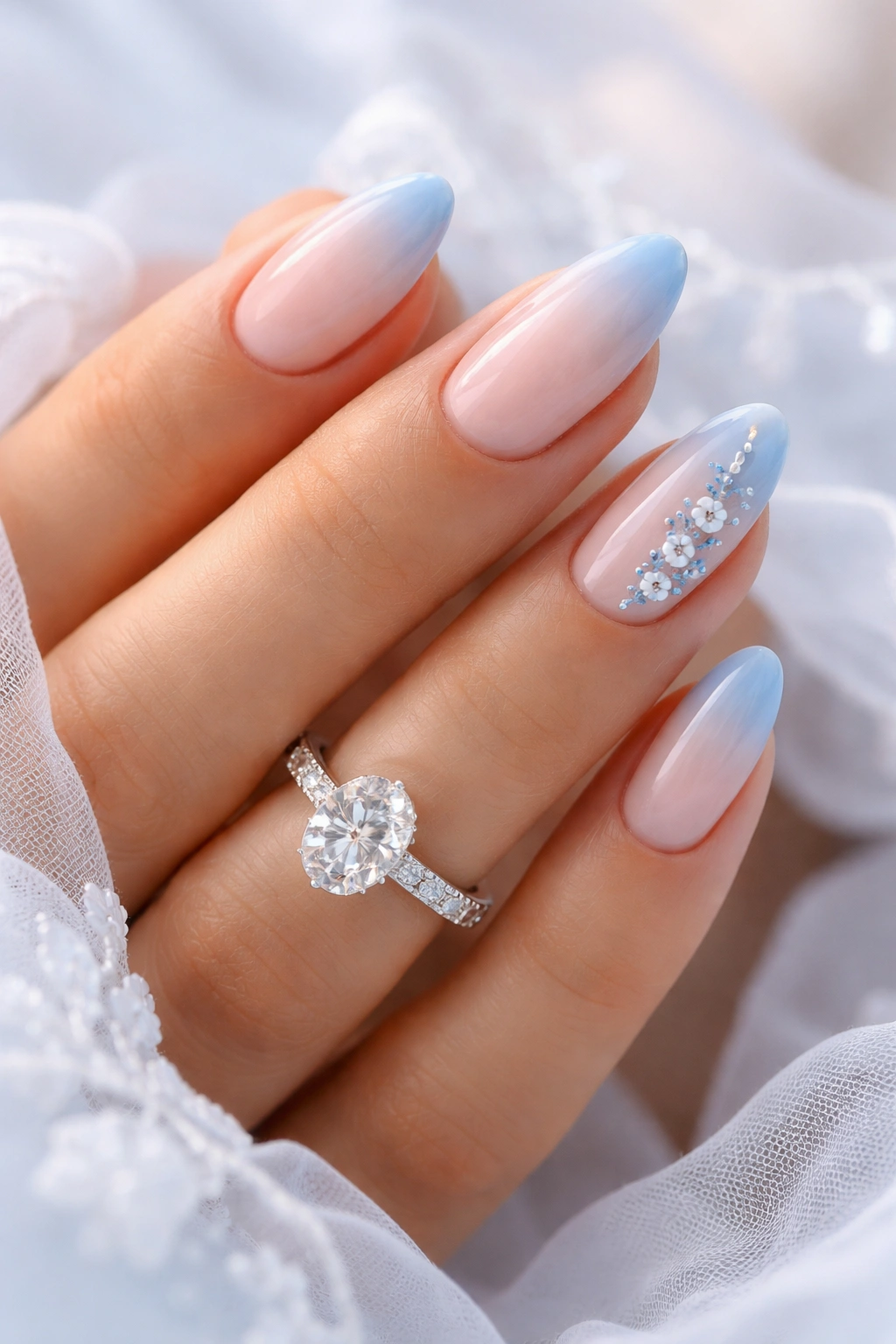 Nails featuring blue accents on a nude base with soft gradient