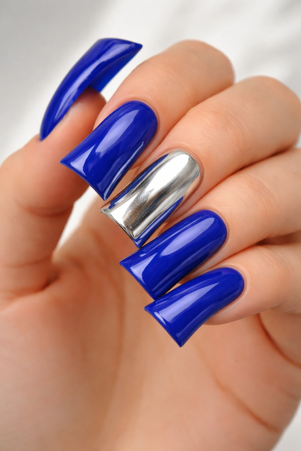 Duck nails with royal blue base and a silver accent nail