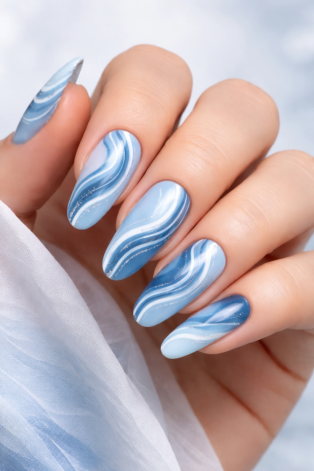 Blue swirl nails in calming blue tones