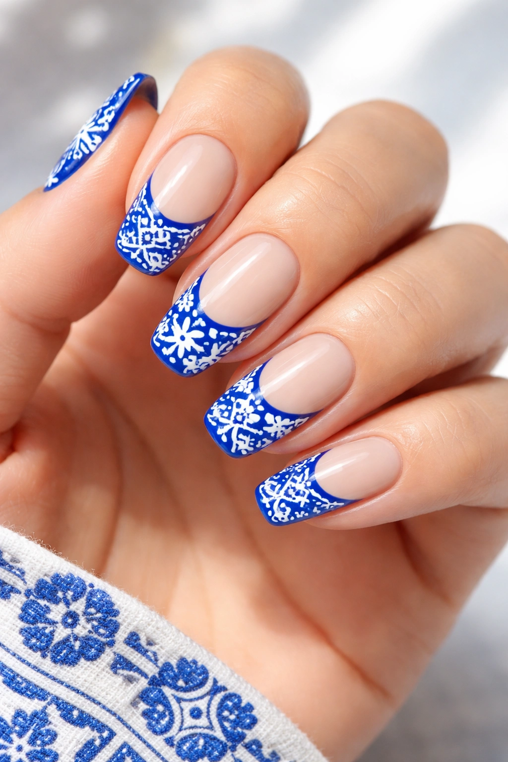 Nails cobalt blue with white tile-patterned accents