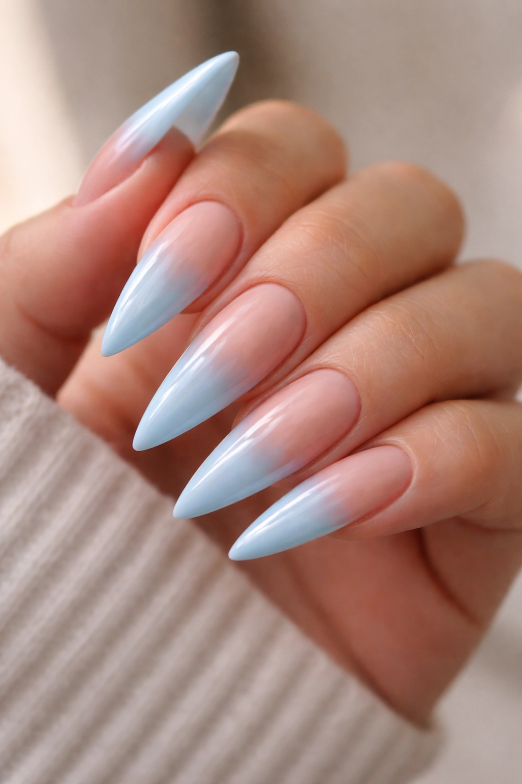 Blue to nude ombré tips on stiletto nails.