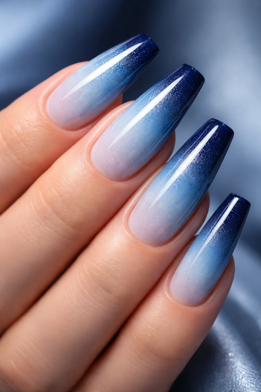 Blue ombre nails gradient from light blue to navy