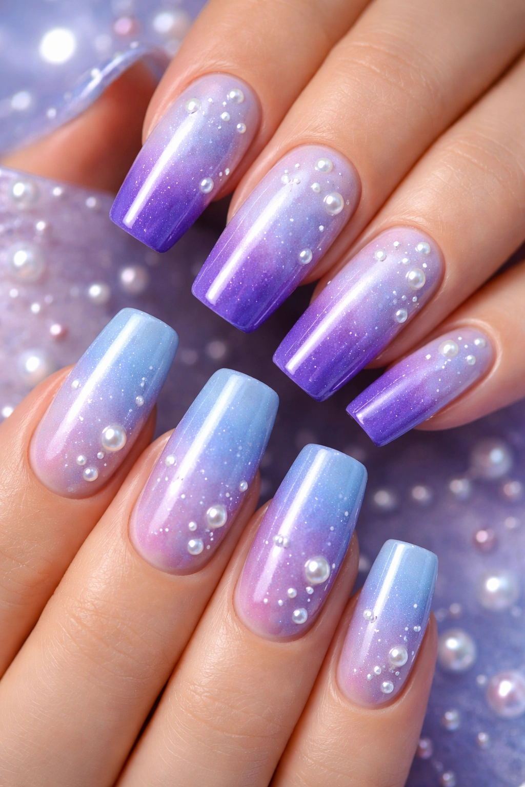 Blue to purple gradient nails with scattered pearls
