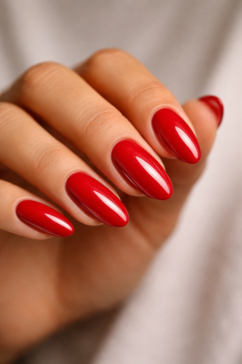 Close-up of long oval nails in blue-red cherry cream
