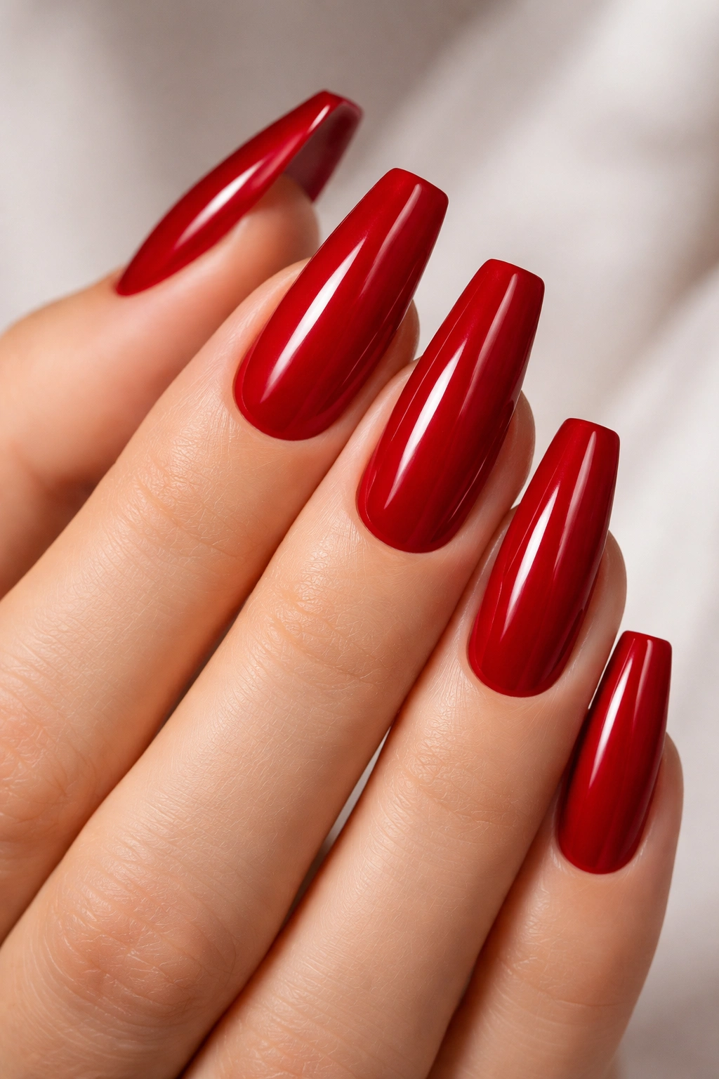 Hand with classic blue-red cream ballerina nails, crisp color