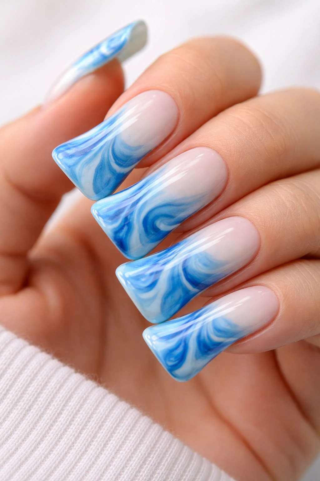 Close-up of blue tie-dye duck nails